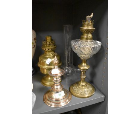 A small proportioned Victorian oil lamp with brass base and twisted well with similar brass style