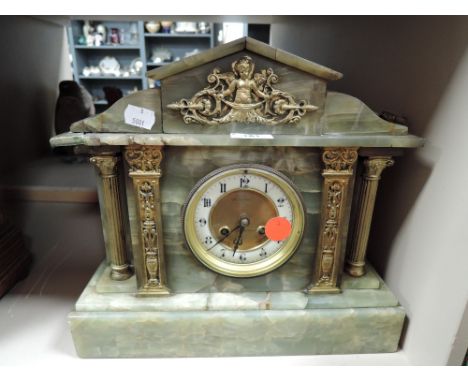 A marble mantel clock with green pillar design by W H Skinner of St Leonards on sea