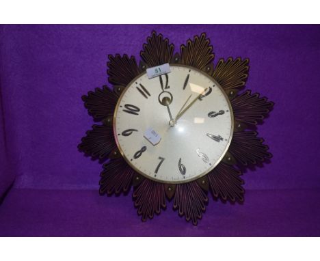 A vintage mid century starburst wall clock by Metamec