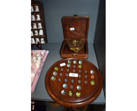 A replica portable inclining sundial with case and a game of peg marbles