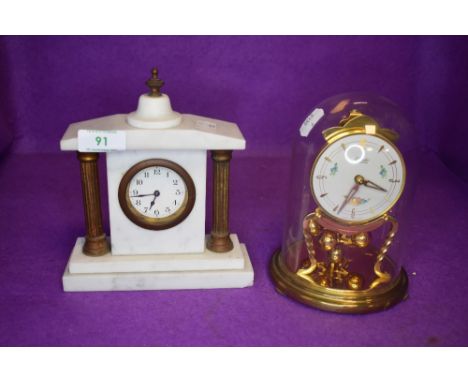 A glass domed anniversary clock by Kundo and a similar marble mantle clock