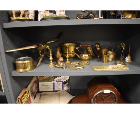 A selection of brass cast figures and candle sticks also a port hole style clock by Sestrel