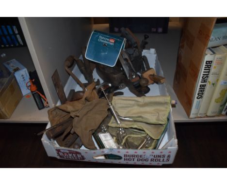An assortment of vintage tools including woodworking planes and medical equipment including syringes.