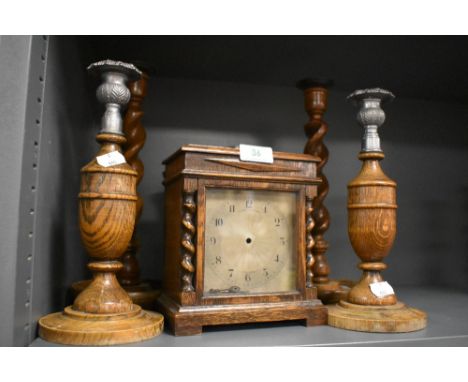 An Ollivant and Botsford of Manchester mantle clock and two pairs or similar oak candle sticks.
Clock body does contain a mov