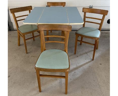 A retro mid century pale blue Formica topped, drop leaf kitchen table with 4 matching chairs. Table raised on 4 tubular natur