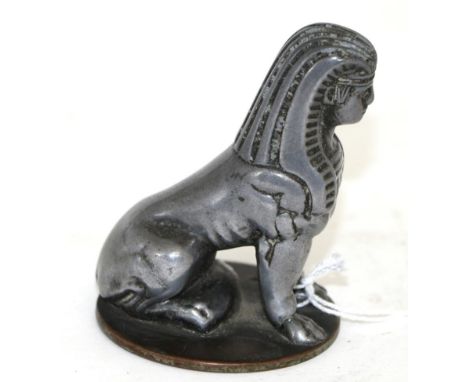 An Art Deco Sphinx Nickel Car Mascot, circa 1920/30, standing on original circular base, 9cm high  Buyer's premium of 20% (+V