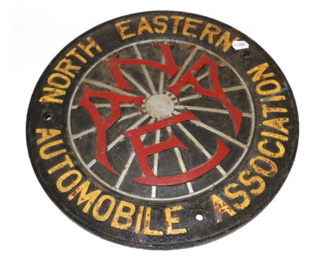 A North Eastern Automobile Association Cast Iron Circular Wall Plaque, early 20th century, the centre in a form of a wheel wi