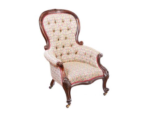 VICTORIAN MAHOGANY BUTTON BACK RUTLAND ARMCHAIR UPHOLSTERED IN FLORAL CLOTH.RAISED ON CARVED CABRIOLELEGS CASTORS.HEIGHT: 43 