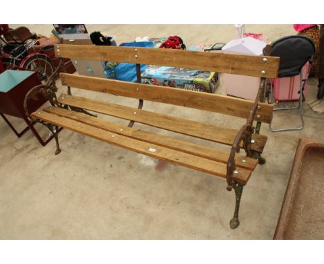 A  WOODEN SLATTED GARDEN BENCH WITH VICTORIAN BLACKBERRY AND VINE CAST BENCH ENDS