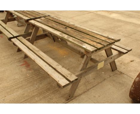 A WOODEN SLATTED GARDEN PICNIC BENCH