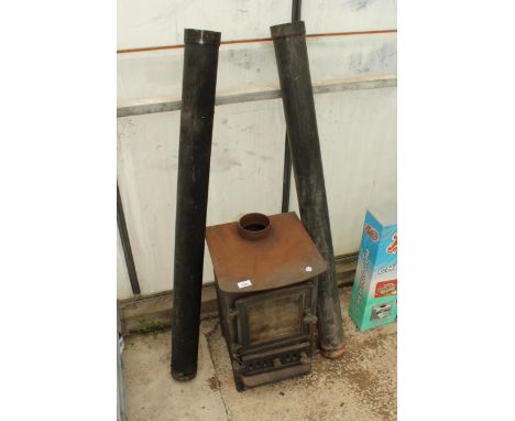A SMALL CAST IRON LOG BURNER WITH FLU PIPE