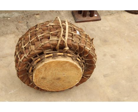 A VINTAGE AFRICAN STYLE TRIBAL DRUM WITH INTERLINKING WOODEN SECTIONS