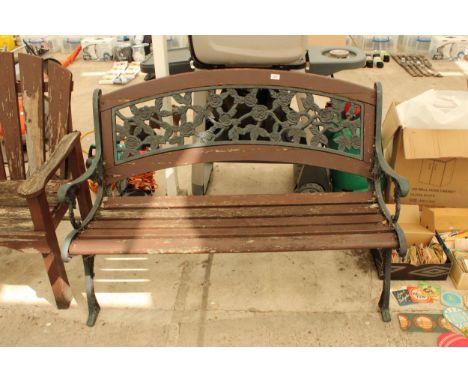 A WOODEN SLATTED GARDEN BENCH WITH CAST ENDS AND CAST FLORAL BACK