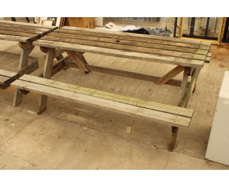 A WOODEN SLATTED GARDEN PICNIC BENCH