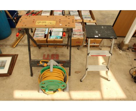 A BLACK AND DECKER FOLDING WORKMATE, A HOSE PIPE AND A STEP LADDER ETC