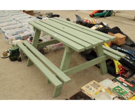 A GREEN PAINTED WOODEN SLATTED PICNIC BENCH