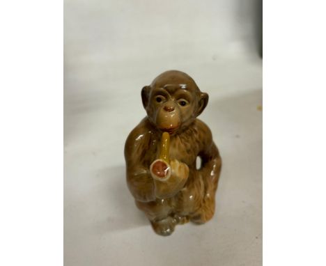 A BESWICK MONKEY SMOKING A PIPE