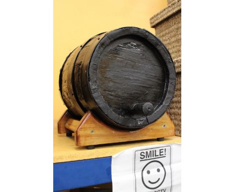 A LARGE VINTAGE BANDED BARREL ON STAND - APPROXIMATELY 50CM LONG