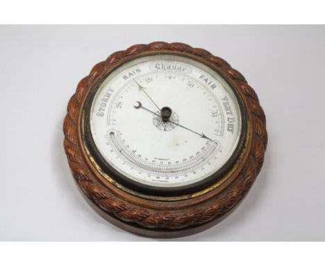 A CARVED WOOD WALL BAROMETER