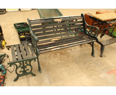 A WOODEN SLATTED GARDEN BENCH WITH CAST ENDS AND A SIMILAR SIDE TABLE