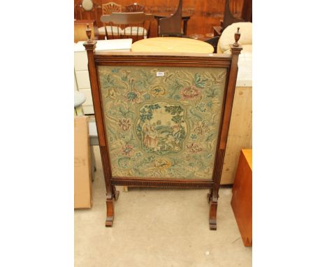 A LATE VICTORIAN OAK FIRESCREEN WITH TAPESTRY PANEL AND VASE SHAPED FINIALS 50" X 30"
