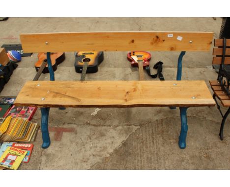 A LARGE PLANK BENCH WITH KNOTTY BENCH ENDS