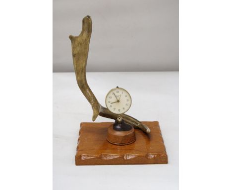 A HORN AND WOOD MANTLE CLOCK