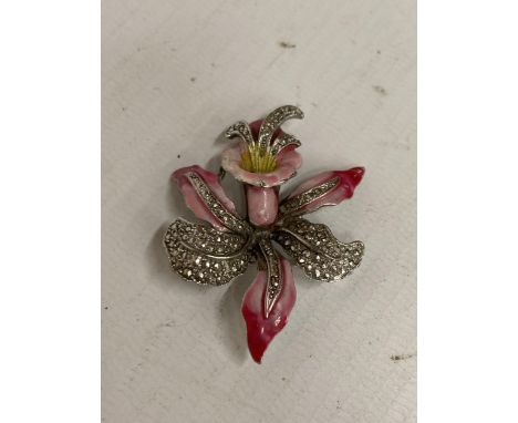 A VINTAGE ENAMELLED AND MARCASITE SET ORCHID DESIGN BROOCH