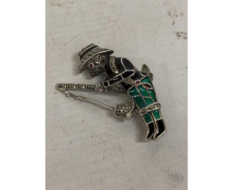 A 925 SILVER AND ENAMEL RUBY EYED FISHING RABBIT BROOCH