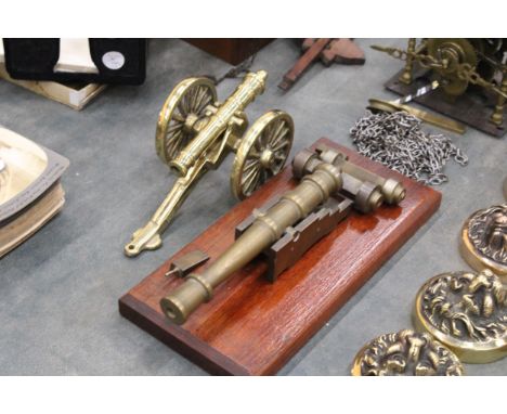 A VINTAGE BRASS CANON ON A WOODEN PLINTH PLUS ONE OTHER