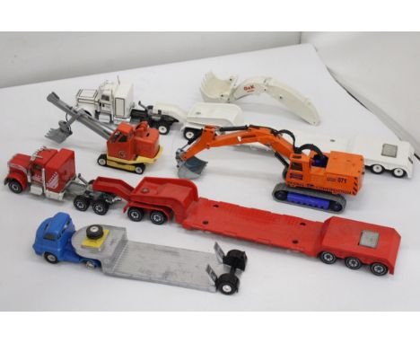 THREE SIKU MODELS WITH MACHINES ON BOARD, PLUS A CORGI TK BEDFORD WITH A PRIESTMAN LOADER ON BOARD - GOOD USED CONDITION