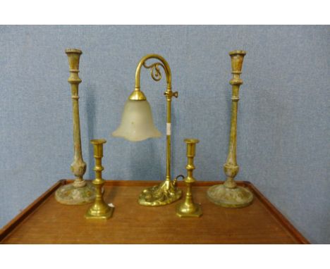 A brass table lamp, a pair of painted candlesticks and a pair of brass candlesticks 