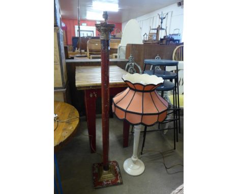 A red and gilt metal standard lamp and a table lamp 