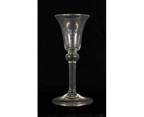 A Wine Glass, circa 1740, the bell shaped bowl over a ball knop and plain stem on folded foot, 15.5cm highFor a related examp