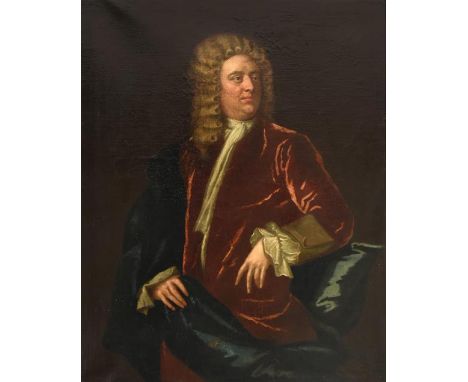 Follower of Sir Godfrey Kneller (1646-1723) Portrait of a gentleman, three quarter length standing wearing a red velvet jacke