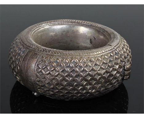 Zanzibar white metal bangle, of thick proportions, decorated with a geometric pattern, 10.5cm wide
