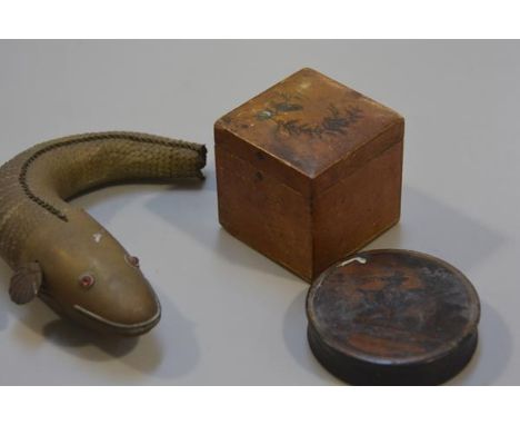An Eastern brass articulated salamander (missing tail), a 19thc treen Chasse aux Perdreaux and a satinwood bird decorated min