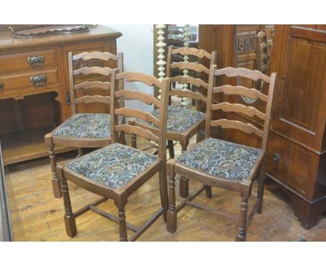 A set of four Ercol ash ladderback dining chairs with slip in seats, raised on turned baluster supports and block feet (h. 88