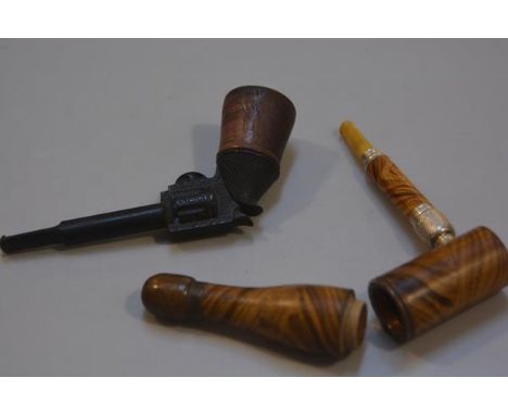 A 19thc treen novelty metamorphic bottle pipe with amberoid mouthpiece and a novelty treen bakelite revolver pipe with treen 