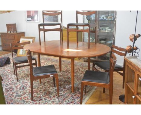 A G Plan 1970s teak seven piece dining suite comprising a circular top extending dining table with magic leaf, with moulded e