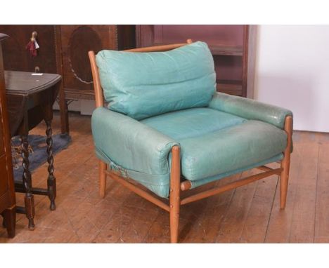 A modern teak framed turquoise leather vintage 1970s style easy chair retailed by Anthropologie, on turned tapered supports (