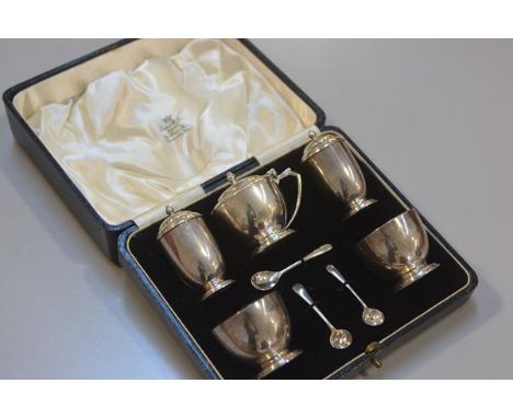 A London silver five piece condiment set including drum mustard, a pair of pepperettes, a pair of salts with glass liners, co