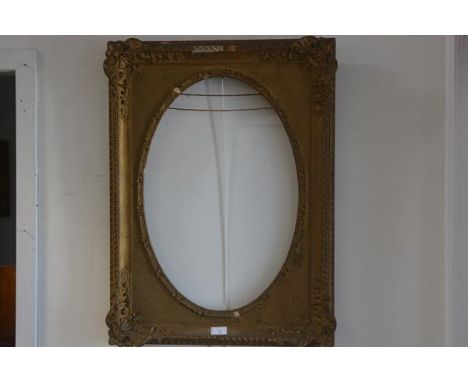 A 19thc. gilt and composition portrait frame with oval aperture with shell and C scroll moulded corners (overall height 99cm 
