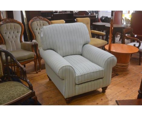 A John Lewis style drawing room easy chair with squab cushions and scroll arms, on walnut fluted turned tapered supports, uph