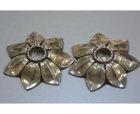 A pair of white metal candlestick holders in Scandinavian style, in the form of open flowers, unmarked (d.8cm), £20-40