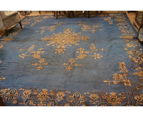 A 1900/1920s Turkey carpet, the centre medallion with radiating lotus flower and leaves, enclosed within a scrolling lotus fl