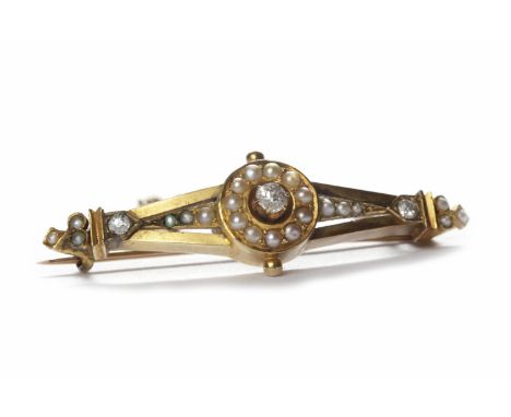 LATE VICTORIAN DIAMOND AND SEED PEARL SET BAR BROOCH set with a single diamond of approximately 0.12 carats surrounded and fl