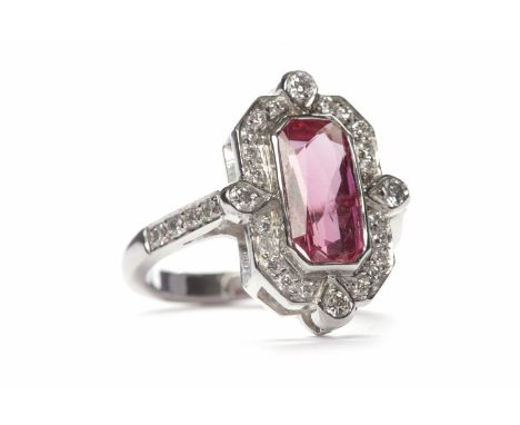 ART DECO STYLE RUBY AND DIAMOND RINGset with a central emerald cut ruby of approximately 2.59 carats surrounded by round bril