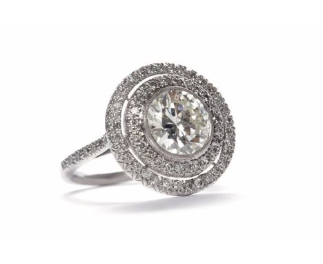 IMPRESSIVE DIAMOND SOLITAIRE RINGthe round brilliant cut diamond of approximately 1.90 carats surrounded by a double halo of 