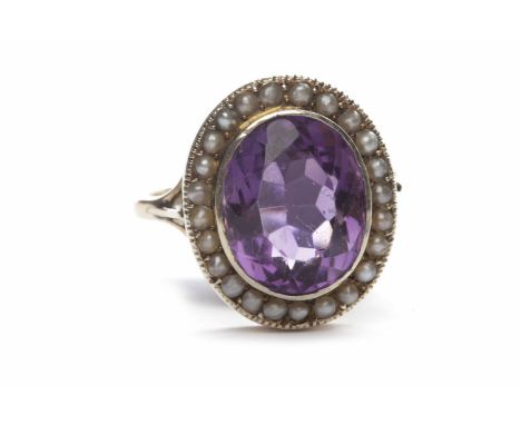 EARLY TWENTIETH CENTURY AMETHYST AND SPLIT PEARL CLUSTER RINGthe central oval amethyst 13mm across and surrounded by split pe